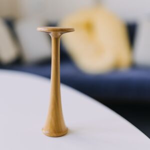 Ein Pinard`sches Hörrohr einer Hebamme steht auch einem Tisch.